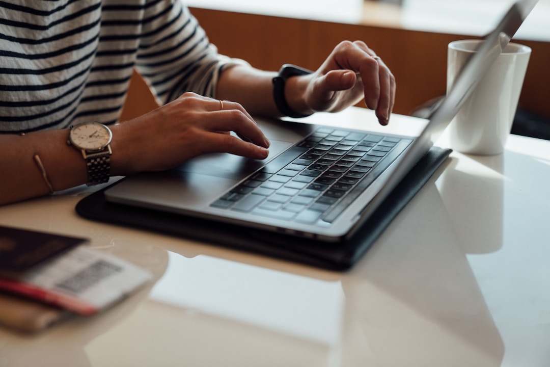 A_person_seated_at_a_laptop_researching_the_benefits_of_knowledge_management_in_a_contact_centerA_person_seated_at_a_laptop_researching_the_benefits_of_knowledge_management_in_a_contact_center.jpeg